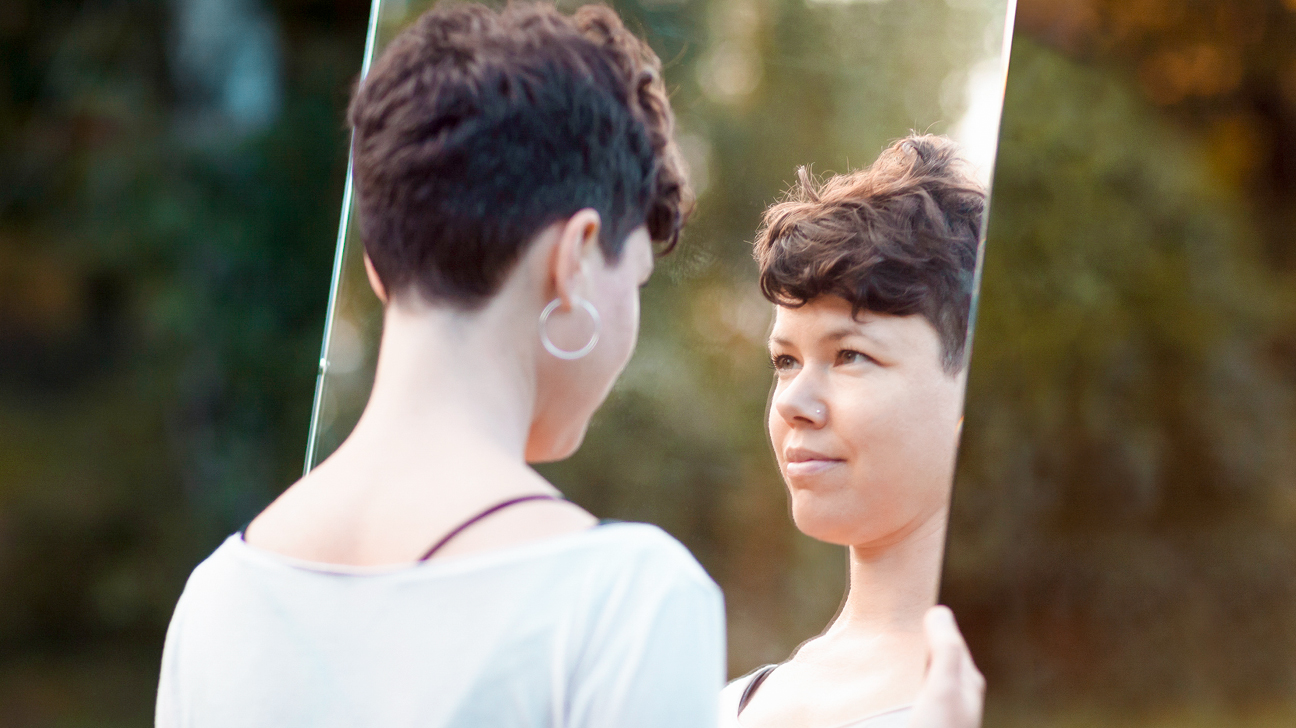 woman-looking-in-mirror-1296x728-header